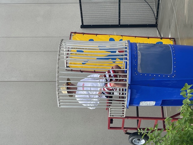 Dunk tank at a summer company cookout — good-natured fun and friendly competition