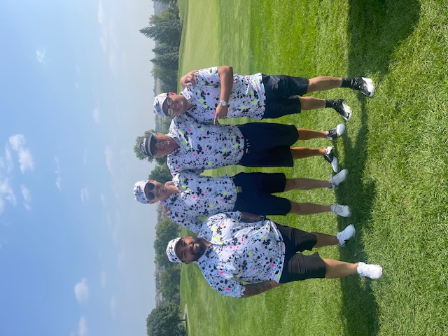 Team golf outing — associates in matching shirts on the course, casual and fun