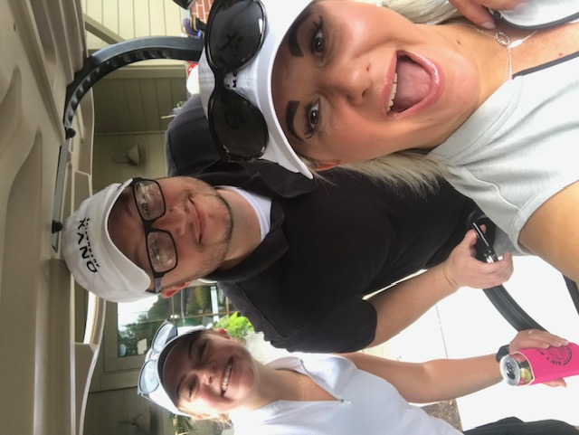 Associates having fun at the company golf outing — a candid selfie between holes