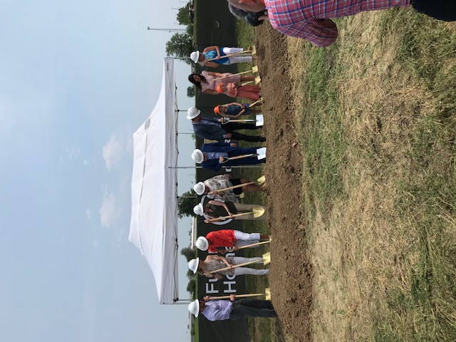Groundbreaking ceremony — H+H leadership in hard hats with golden shovels at a new site
